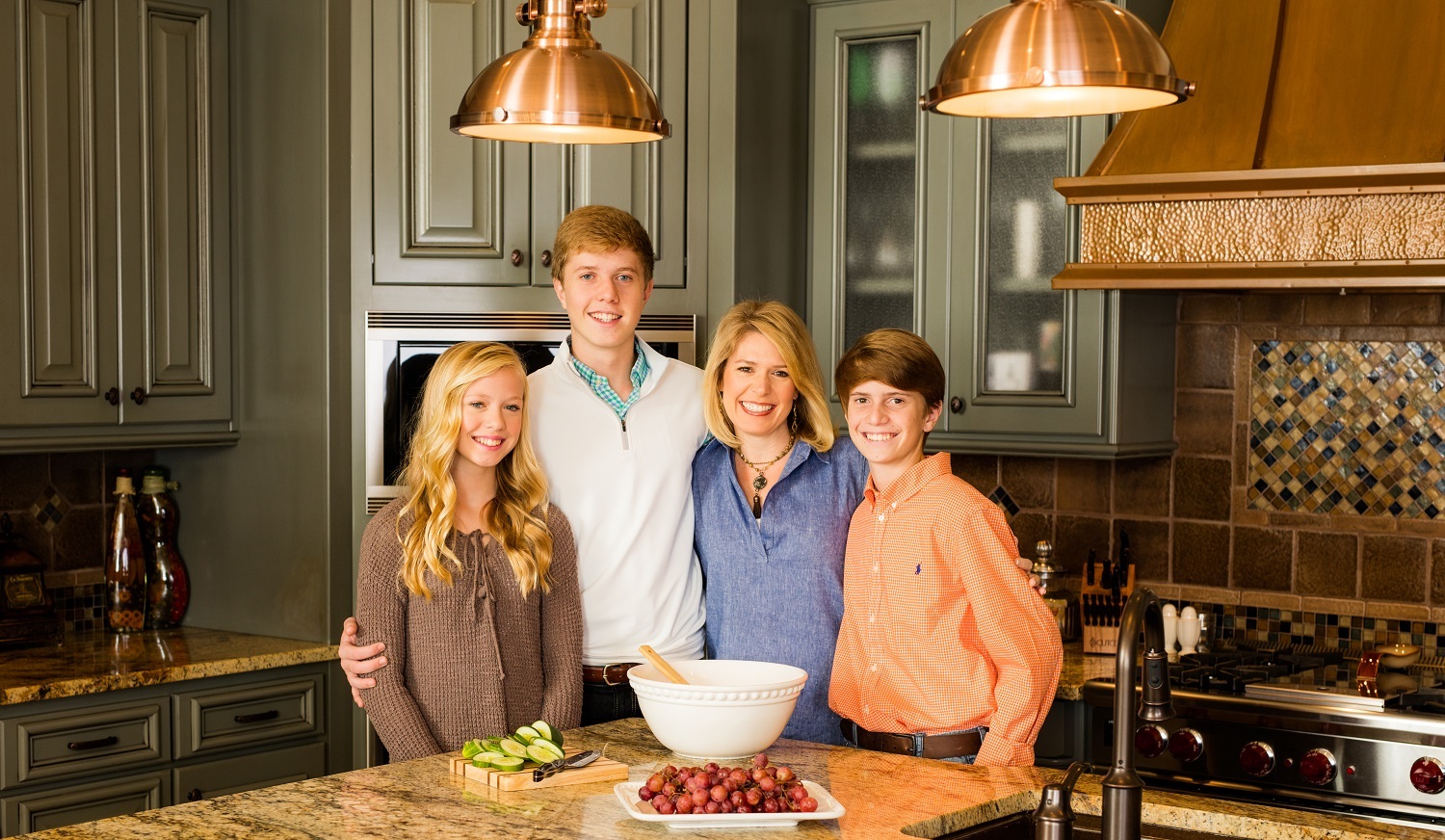 Stacy Brown with children smiling in kitchen